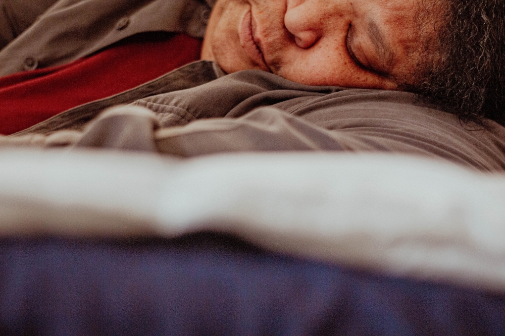 A woman sleeps in Brooklyn, March 1, 2024. (Laila Stevens/The New York Times)