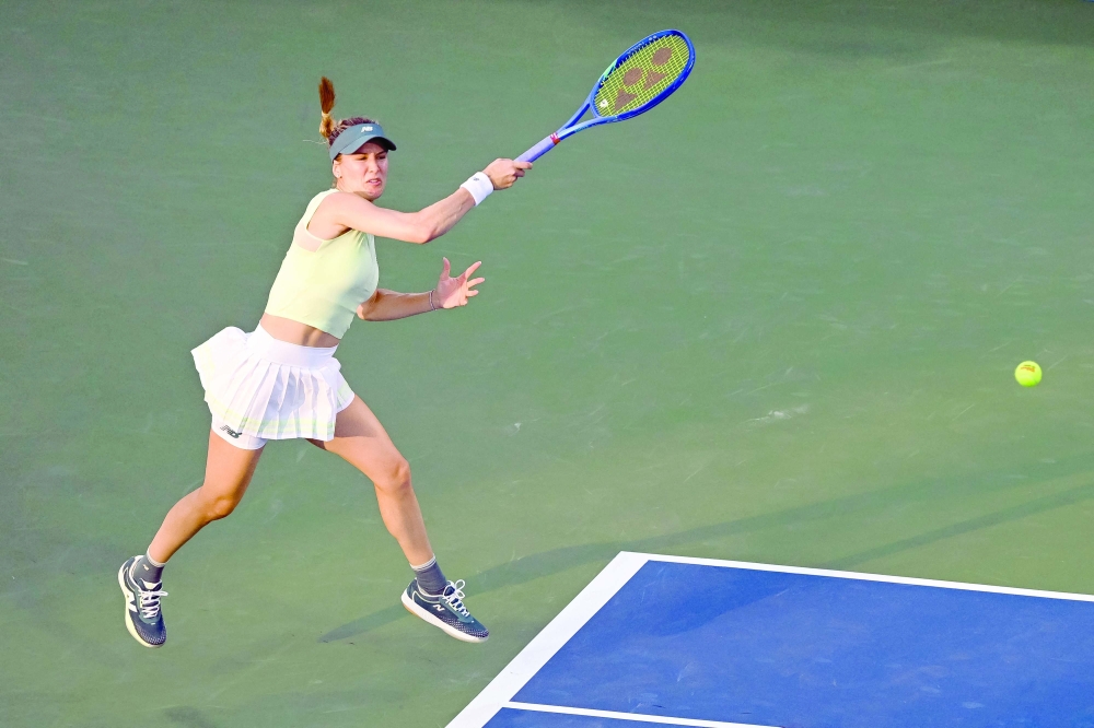 Eugenie Bouchard (CAN) returns the ball against Emiliana Arango (COL) in first round play at IGA Stadium. — Reuters