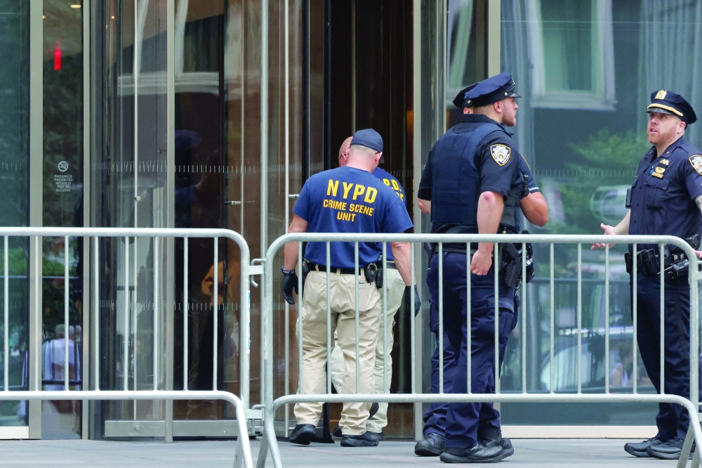 Members of the NYPD Crime Scene Unit work at the scene of a deadly mass shooting in Manhattan. — Reuters 