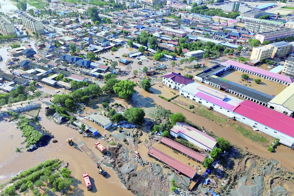 A drone view shows partially submerged village houses and other buildings in Miyun. — Reuters