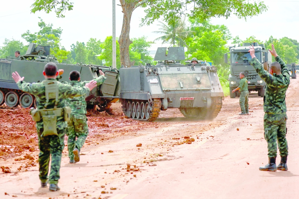 Armoured personnel carriers (APC) are seen on a road near Thailand-Cambodia's border in Sisaket province. — Reuters