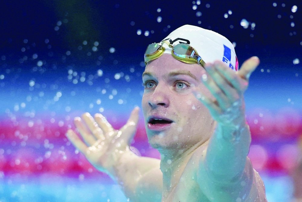 France's Leon Marchand celebrates after winning semifinal 2. — Reuters