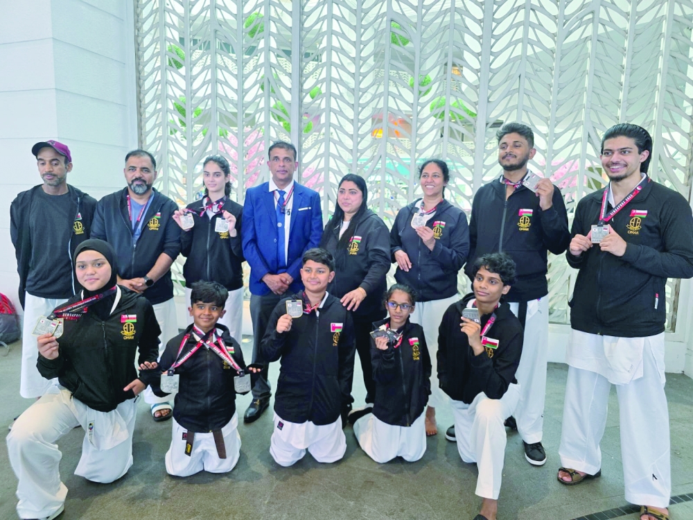 Oman team members pose with their medals.