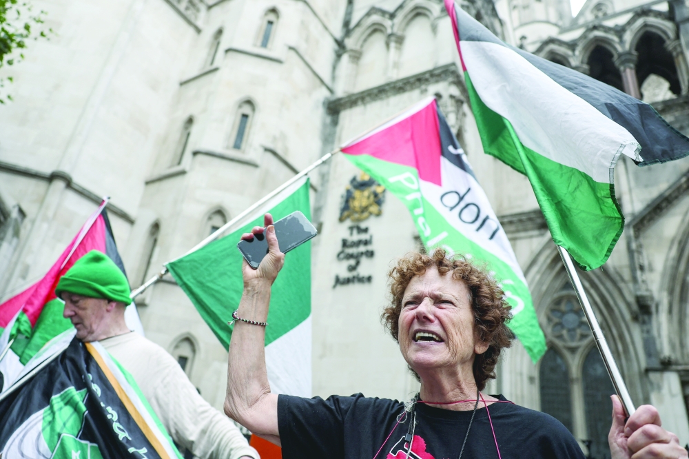 
People gather outside as Palestine Action’s co-founder wins bid to challenge ban, in London. — Reuters 