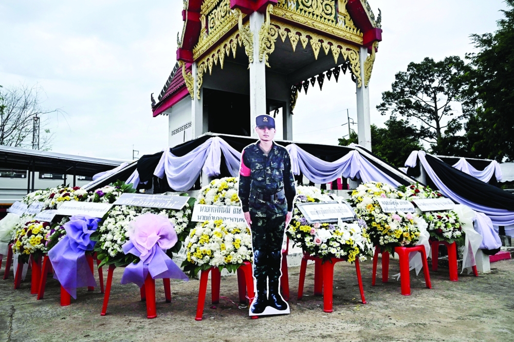 A cardboard cutout of Royal Thai Army soldier Teerayuth Krajangthong, who died during clashes between Thailand and Cambodia in Sisaket province, is seen during funeral rites at a Buddhist temple in the Thai border province of Buriram. - AFP