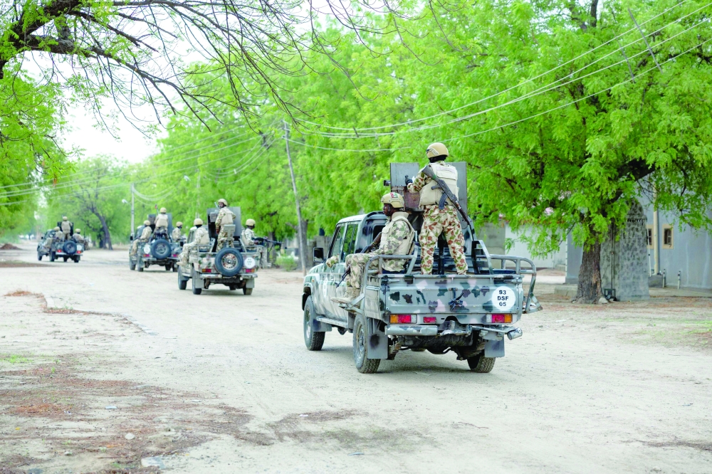 Nigerian soldiers from the Multinational Joint Task Force (MNJTF) drive around in pick-ups during training at the MNJTF military base, in Borno state, Nigeria. — AFP