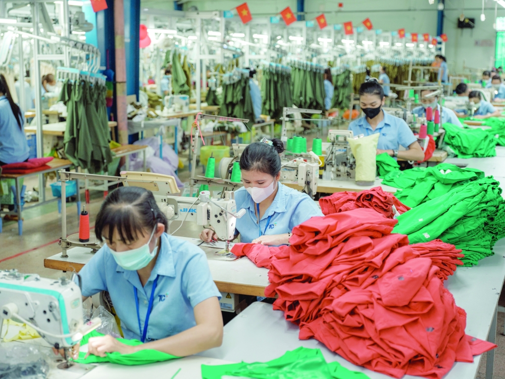 Workers at a clothing factory in Ho Chi Minh, Vietnam, where 60 percent of fabrics for manufacturing come from China. — NYT 