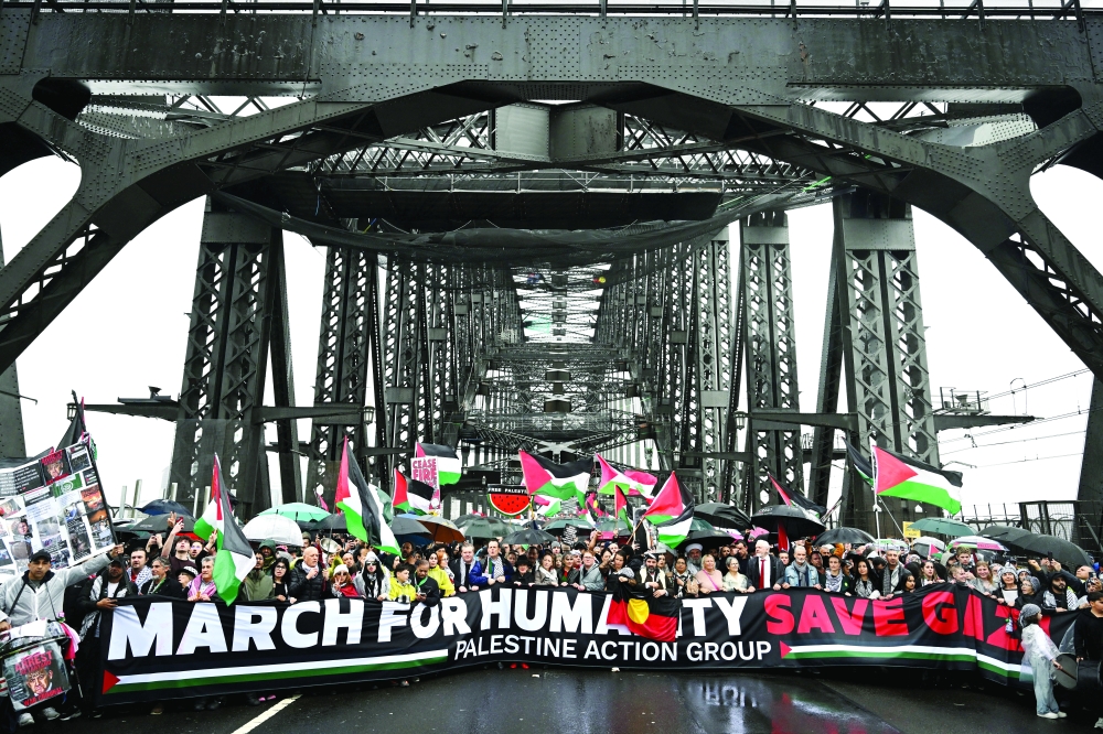 
Protesters walk across the Sydney Harbour Bridge during the Palestine Action Group’s March for Humanity. — Reuters 