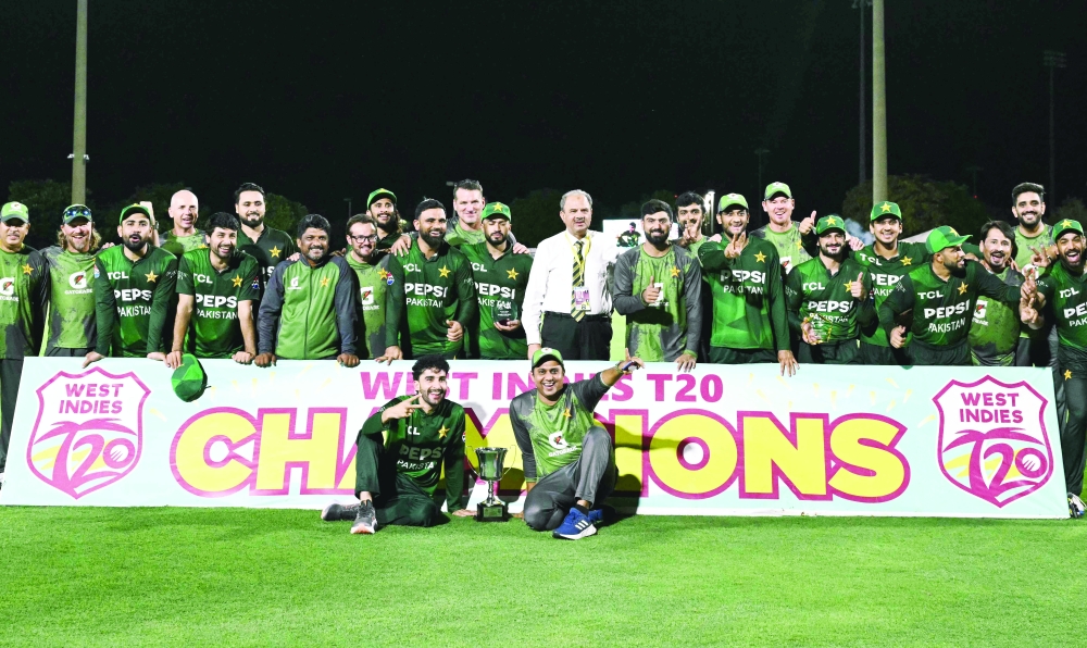 Pakistan players pose with the trophy after their team won the third Twenty20 (T20) international, sealing a 2–1 series victory over West Indies, at Central Broward Park & Broward County Stadium in Lauderhill, Florida, on August 3, 2025. (Photo by Chandan Khanna / AFP)
