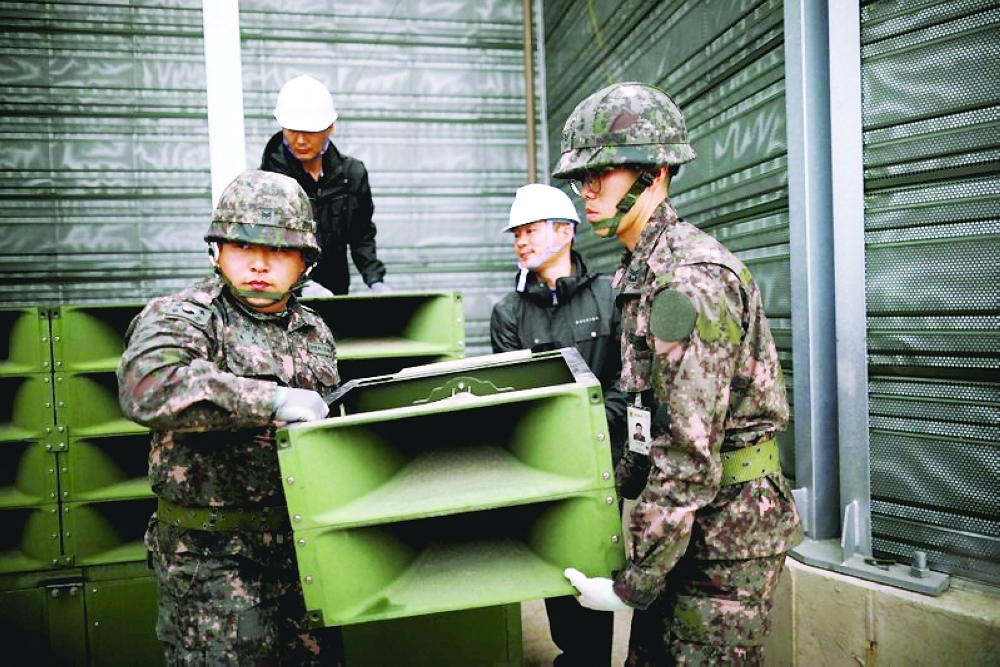 
South Korean soldiers dismantle loudspeakers, in Paju. — Reuters 