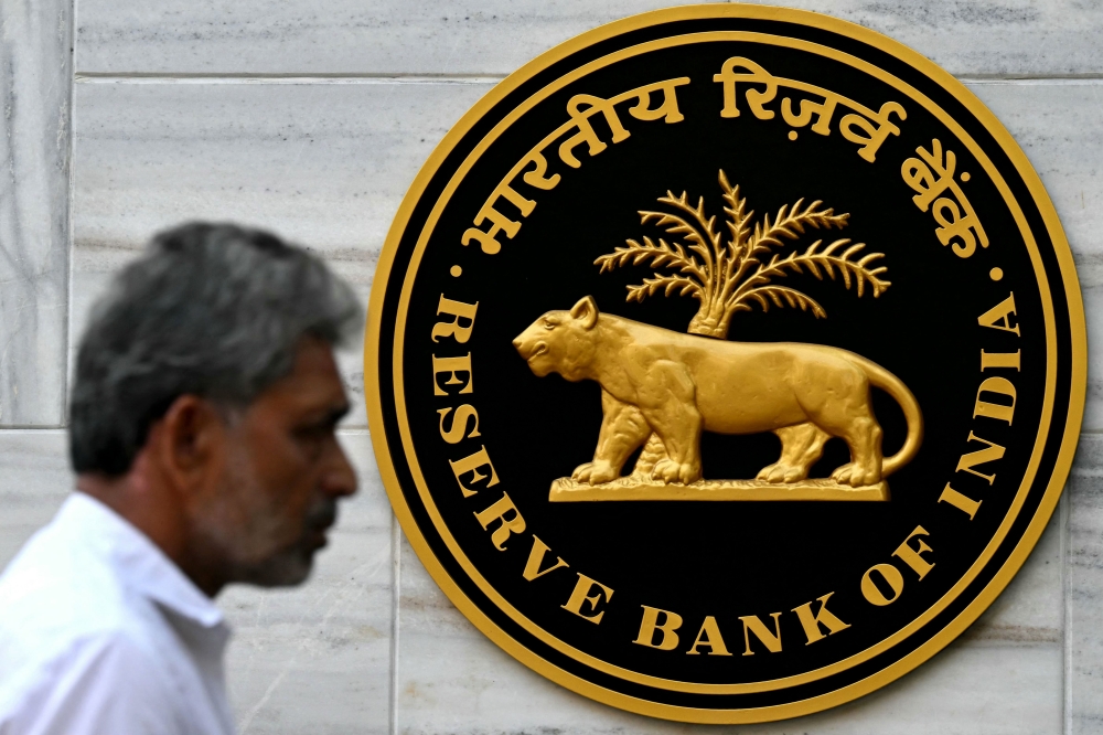 A pedestrian walks past the Reserve Bank of India (RBI)
