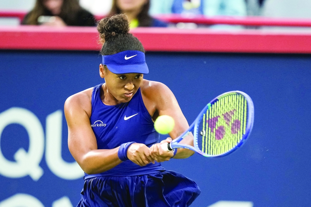 Naomi Osaka (JPN) returns the ball to Elina Svitolina (UKR) in quarterfinal play at IGA Stadium. — Imagn Images