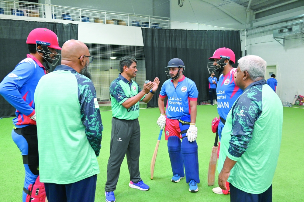 Oman's support staff working with the team.