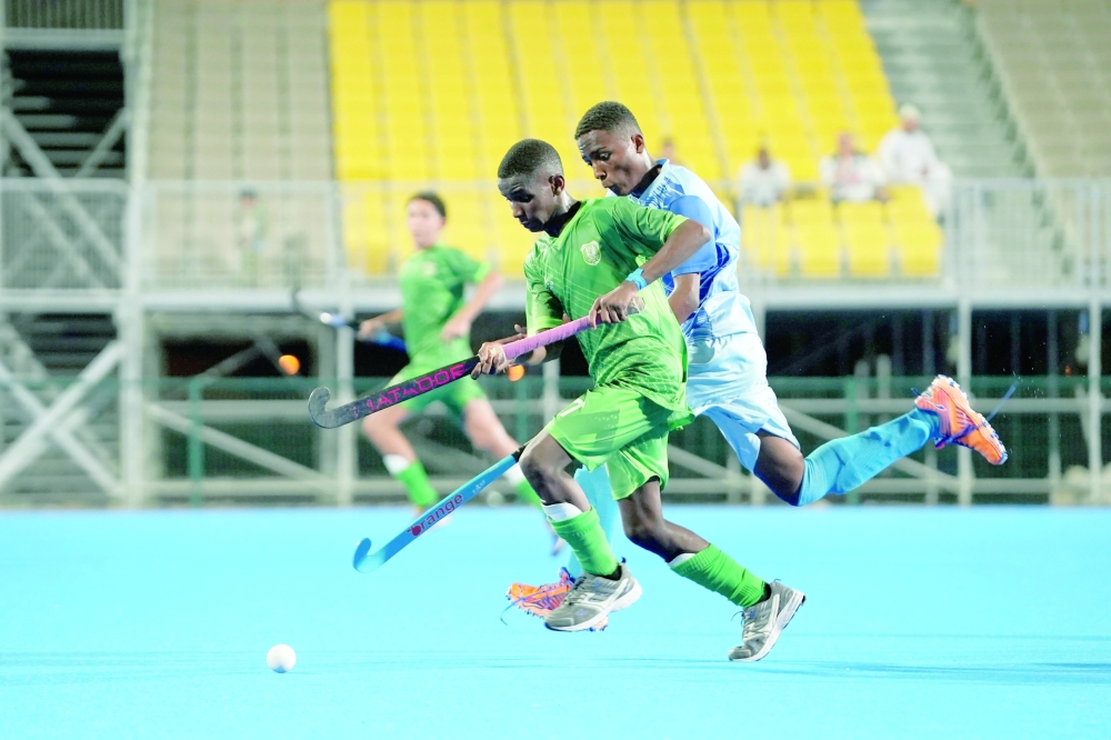 Al Ittihad and Masirah players in action.