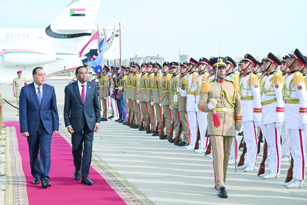 Egypt's Prime Minister Mostafa Madbouly welcomes his counterpart from Sudan Kamil Idris upon his arrival at the Cairo International airport in Egypt's capital. - AFP
