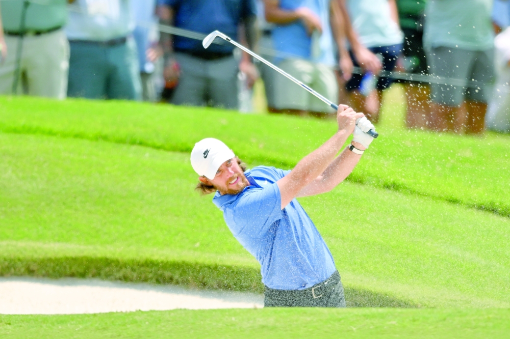 Tommy Fleetwood plays a shot from a bunker on the 18th hole during the second round of the FedEx St. Jude Championship golf tournament. — Imagn Images