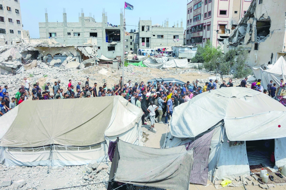 Mourners march with the bodies of the journalists from Al Shifa hospital, in Gaza. — AFP