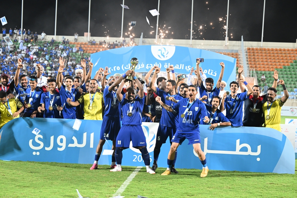 Ittihad Daghmar players celebrate with their trophy. -- Abdulwahid al Hamadani