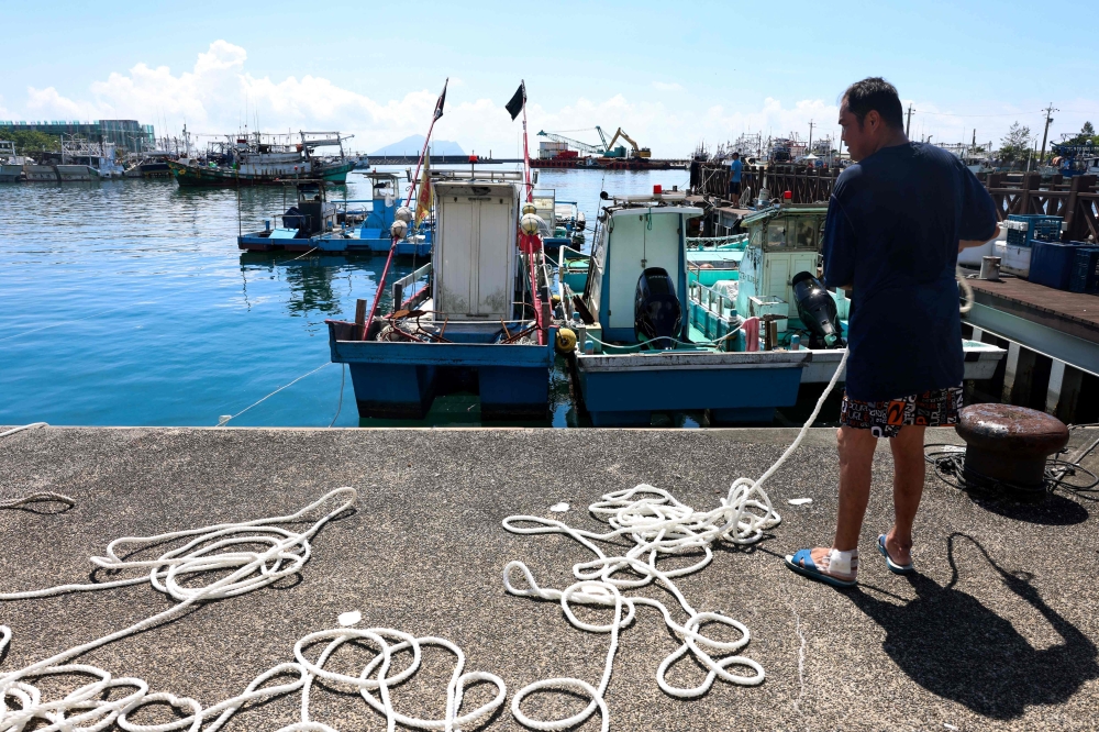 Fishermen secure their boats at Wushih Harbor in Yilan as Typhoon Podul approaches on August 12, 2025 (Photo by I-Hwa Cheng / AFP)
