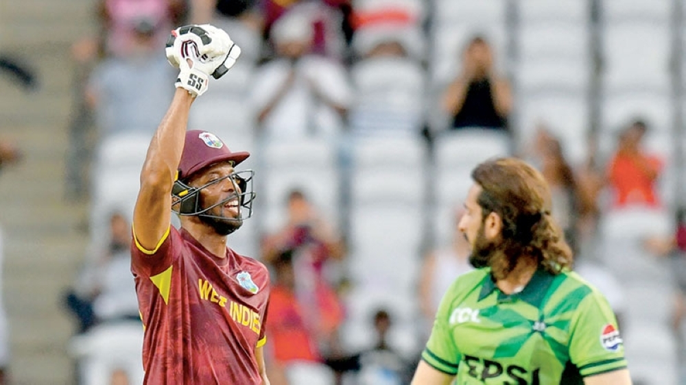 Roston Chase (L) of West Indies celebrates winning the second One Day International (ODI) cricket match between West Indies and Pakistan at Brian Lara Cricket Academy in Tarouba, San Fernando, Trinidad and Tobago.  (Photo by Randy Brooks / AFP)