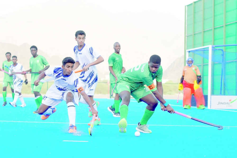 Al Ittihad and Masirah players in action.