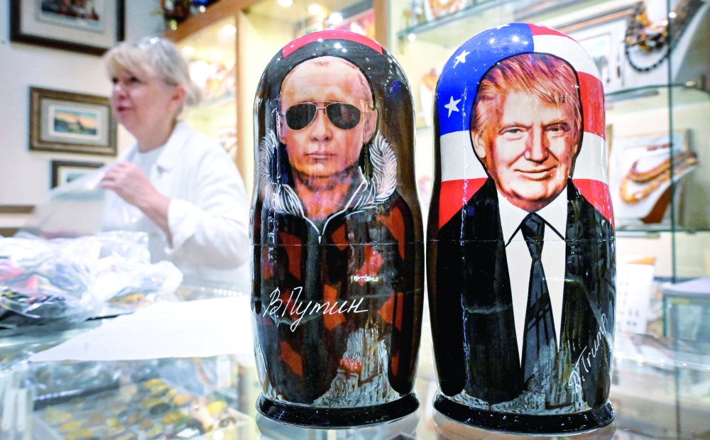 
Traditional Russian wooden nesting dolls depicting Vladimir Putin and Donald Trump at a gift shop in Moscow. — AFP 
