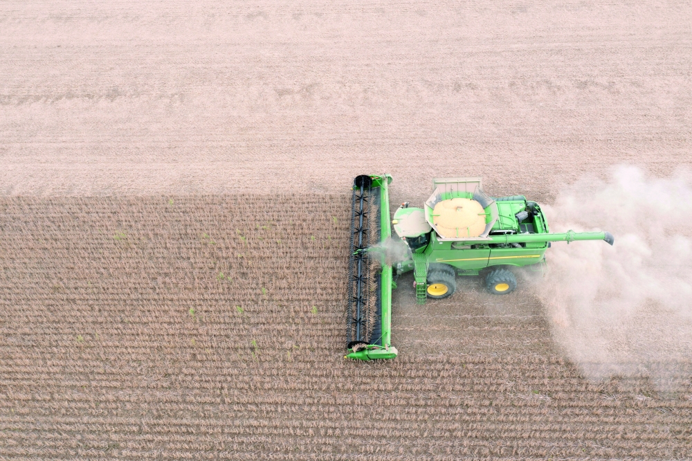 An aerial view of a combine harvester as it harvests soybeans in Deerfield, Ohio. — Reuters