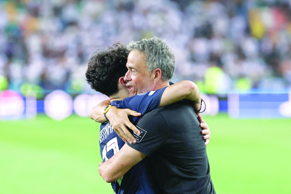 Paris Saint-Germain's Spanish head coach Luis Enrique (R) embraces Paris Saint-Germain's Portuguese midfielder #17 Vitinha (L) as they celebrate winning the 2025 Uefa Super Cup final football match between Paris Saint-Germain (FRA) and Tottenham Hotspur FC (ENG) at the Friuli stadium, in Udine, on August 13, 2025. (Photo by FRANCK FIFE / AFP)