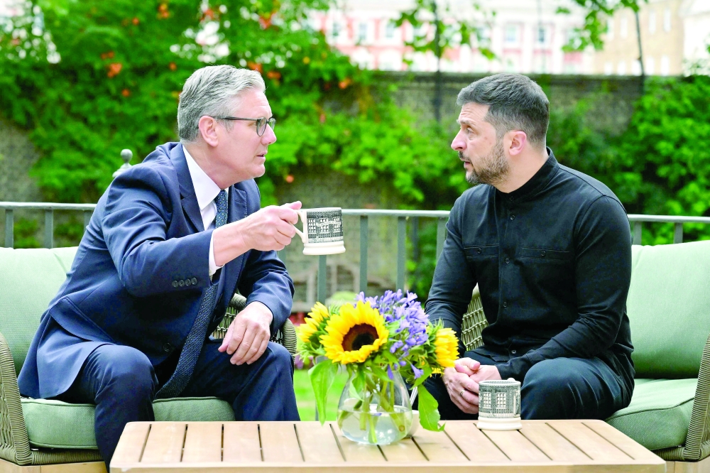 Britain's Prime Minister Keir Starmer with Ukraine's President Volodymyr Zelensky in the garden of 10 Downing Street in central London. - AFP
