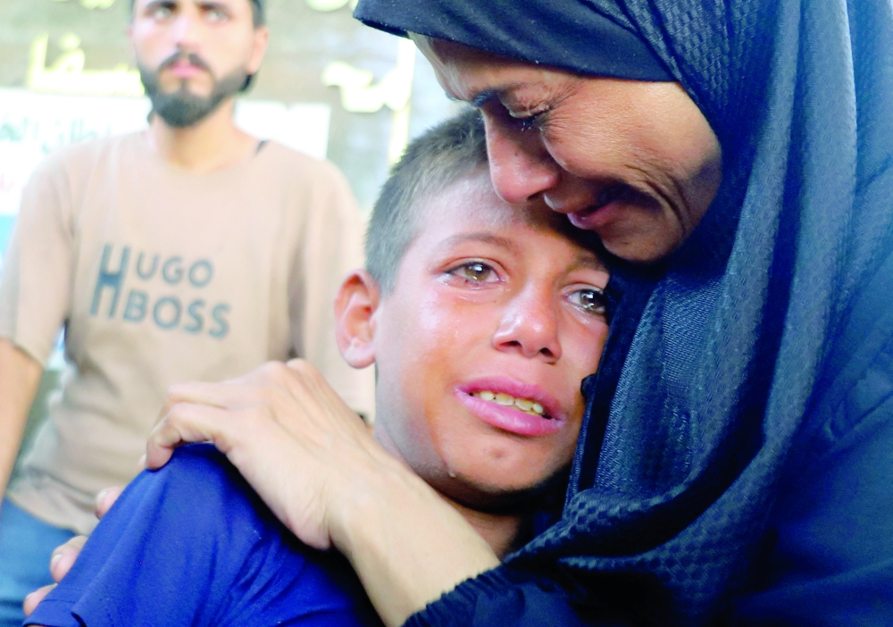 Mourners react during the funeral of Palestinians killed in Israeli fire while seeking aid, in Gaza City, on Thursday. - Reuters
