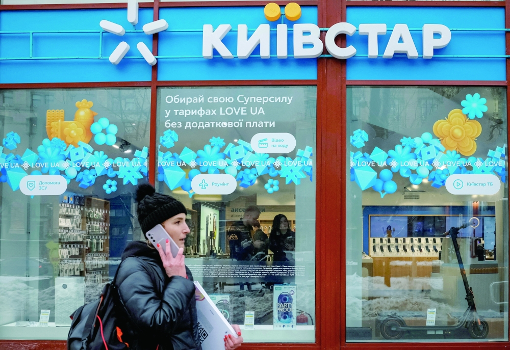 A woman walks past a store of Ukrainian telecoms company Kyivstar, Ukraine. — Reuters File