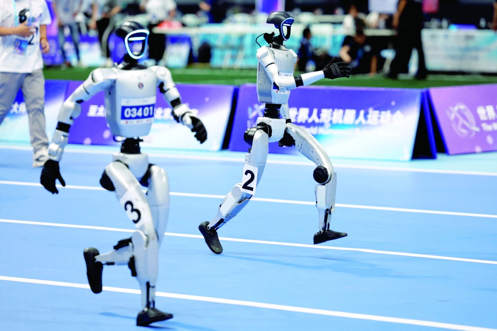 Humanoid robots compete in the 1500m final at the inaugural World Humanoid Robot Games, at the National Speed Skating Oval in Beijing. — Reuters