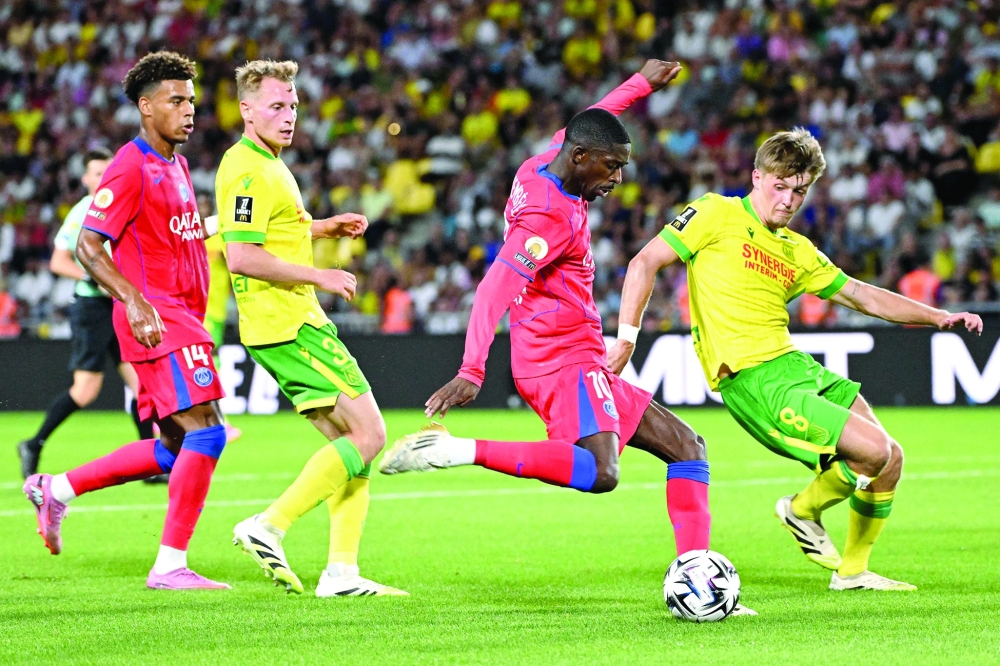Nantes' French midfielder #08 Johann Lepenant (R) and Paris Saint-Germain's French forward #10 Ousmane Dembele (2R) fight for the ball during the French L1 match in Nantes, western France. — AFP
