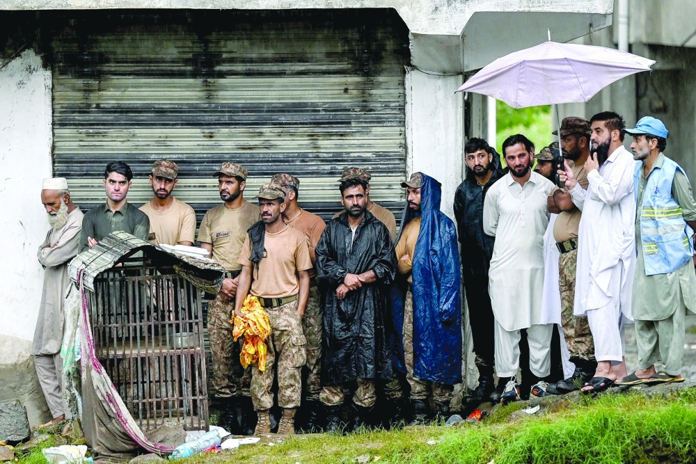 Rescuers and army personnel take shelter