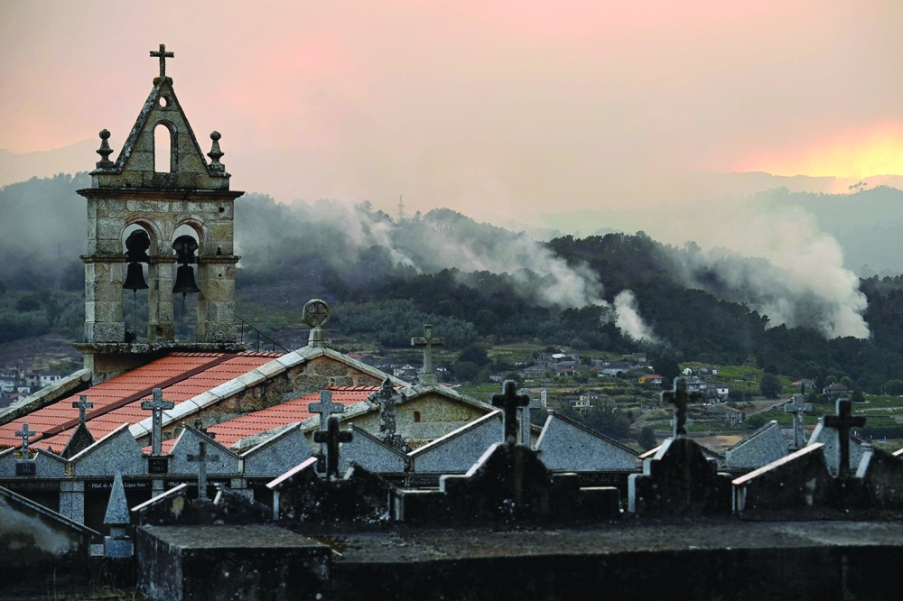 A wildfire burns near the village of Esposende, in the Spanish municipality of Cenlle. — AFP