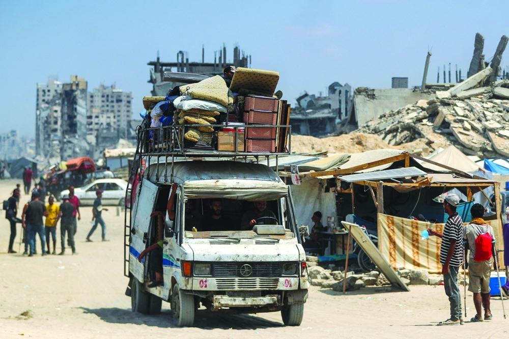 Displaced Palestinians fleeing northern Gaza travel in a vehicle loaded with their belongings. — Reuters