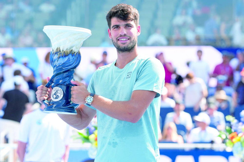 Carlos Alcaraz (ESP) poses with the Rookwood Cup after his match against Jannik Sinner (ITA) during the Cincinnati Open at the Lindner Family Tennis Center. — Imagn Images