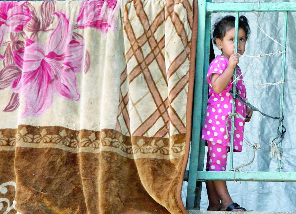 A Palestinian child shelters in an UNRWA school, in Khan Yunis. — Reuters