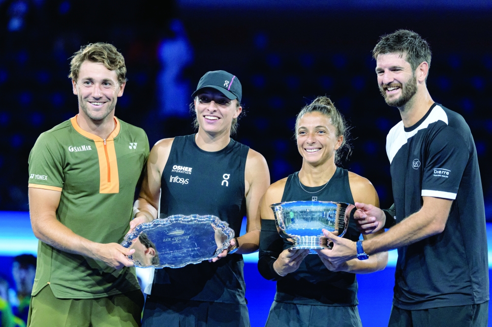 Sara Errani of Italy and Andrea Vavassori of Italy pose with the winner’s trophy after their victory over Casper Ruud of Norway and Ina Swiatek of Poland who pose with the runner-up’s trophy after the final of the mixed doubles tournament at the US Open at Arthur Ashe Stadium. — Imagn Images