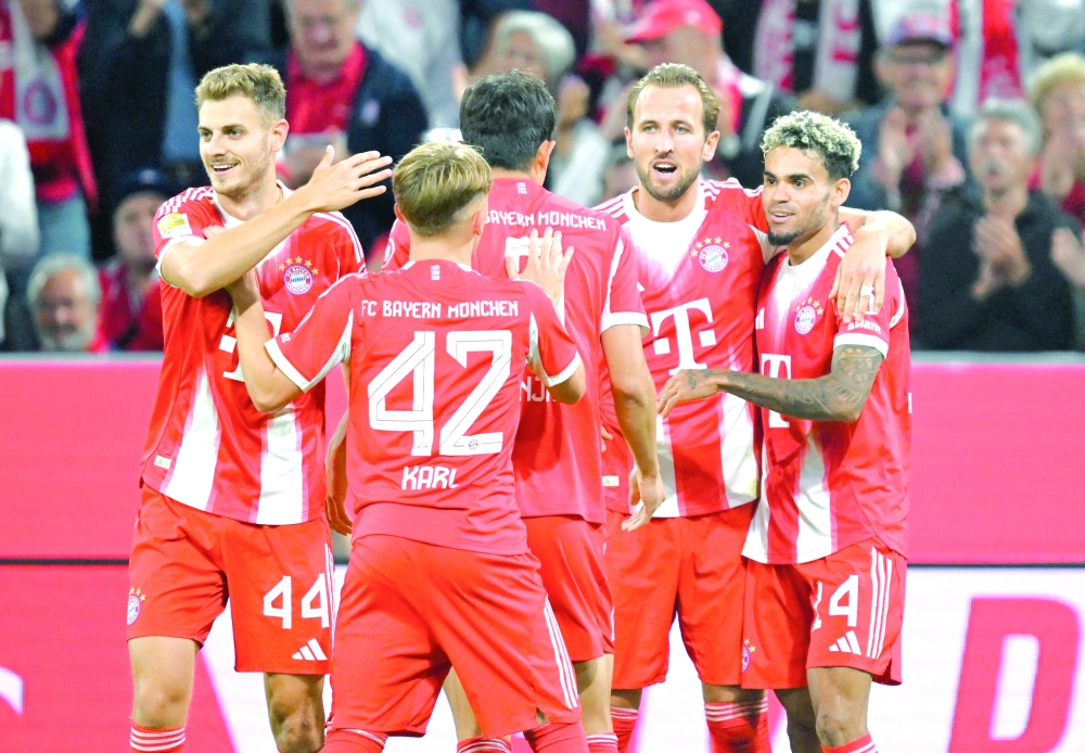 Harry Kane celebrates scoring the fifth goal with teammates. —Reuters