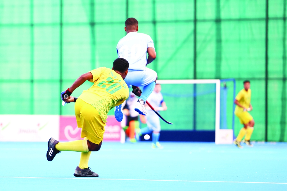 Action heats up as Masirah’s striker leaps over a challenge from Seeb’s.