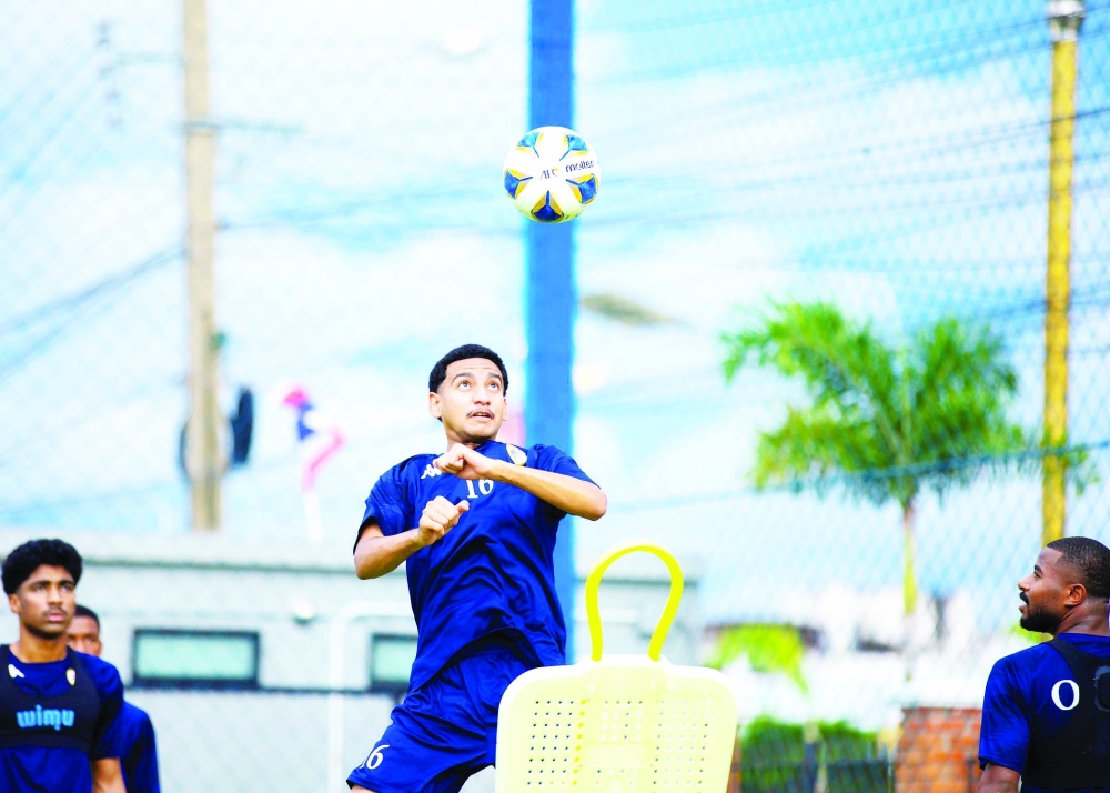 An Oman Olympic player contests a header during training