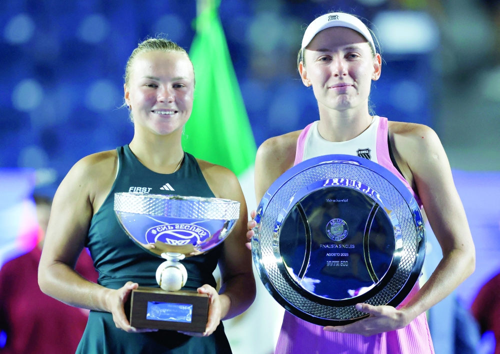 Russia's Diana Shnaider poses with the trophy after winning the Monterrey Open alongside runner up Russia's Ekaterina Alexandrova. — Reuters