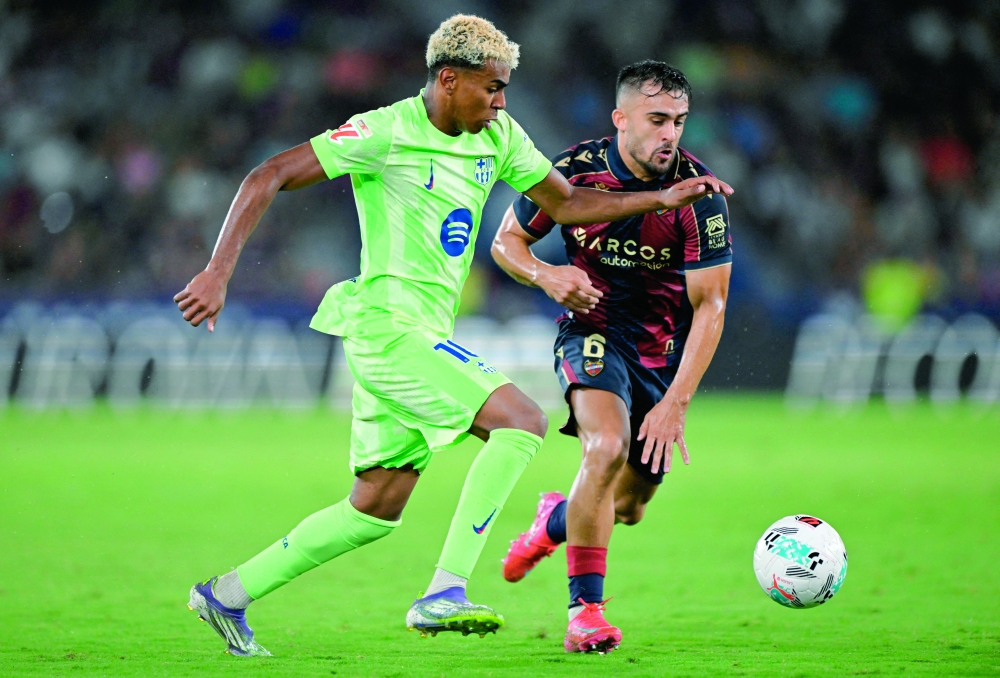 FC Barcelona's Lamine Yamal in action with Levante's Diego Pampin. — Reuters