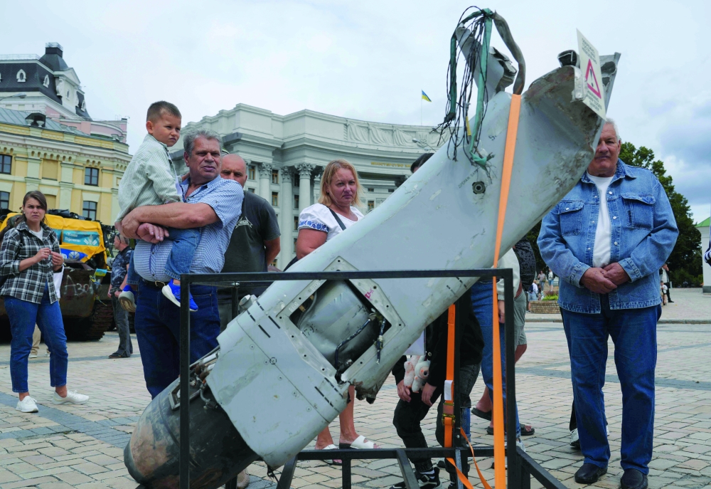 Local residents look at captured military equipment in Kyiv on Ukraine's Independence Day. — AFP