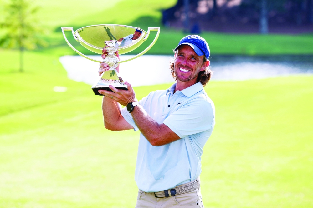 Tommy Fleetwood poses for a photo with the FedExCup Trophy after winning the TOUR Championship golf tournament. — Imagn Images