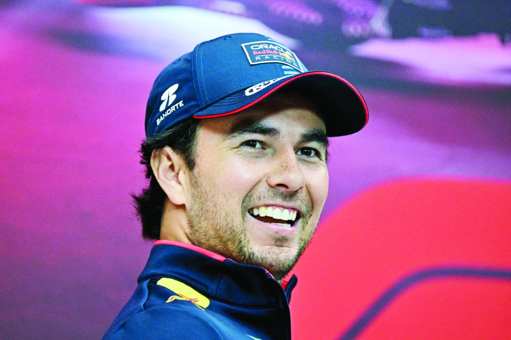 (FILES) Red Bull Racing's Mexican driver Sergio Perez smiles during a press conference ahead of the Qatari Formula One Grand Prix at the Lusail International Circuit in Lusail, north of Doha, on November 28, 2024. Former Red Bull driver Sergio Perez and former Mercedes driver Valtteri Bottas will drive for Cadillac next season, the new Formula One team announced on August 26, 2025. (Photo by Andrej ISAKOVIC / AFP)