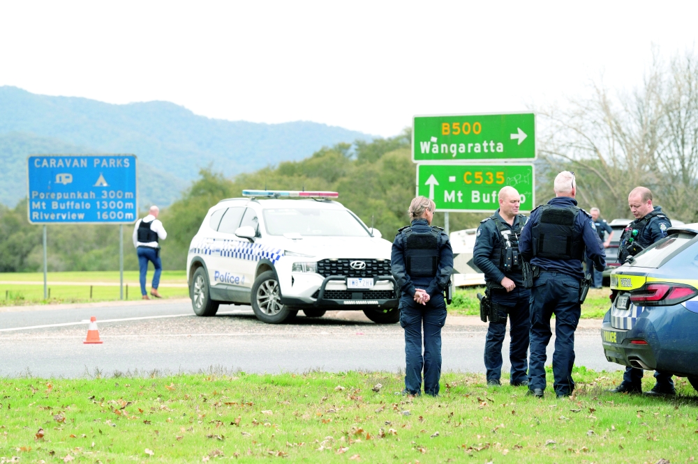 Police stand at the scene of a shooting in Porepunkah, Victoria, Australia. — Reuters