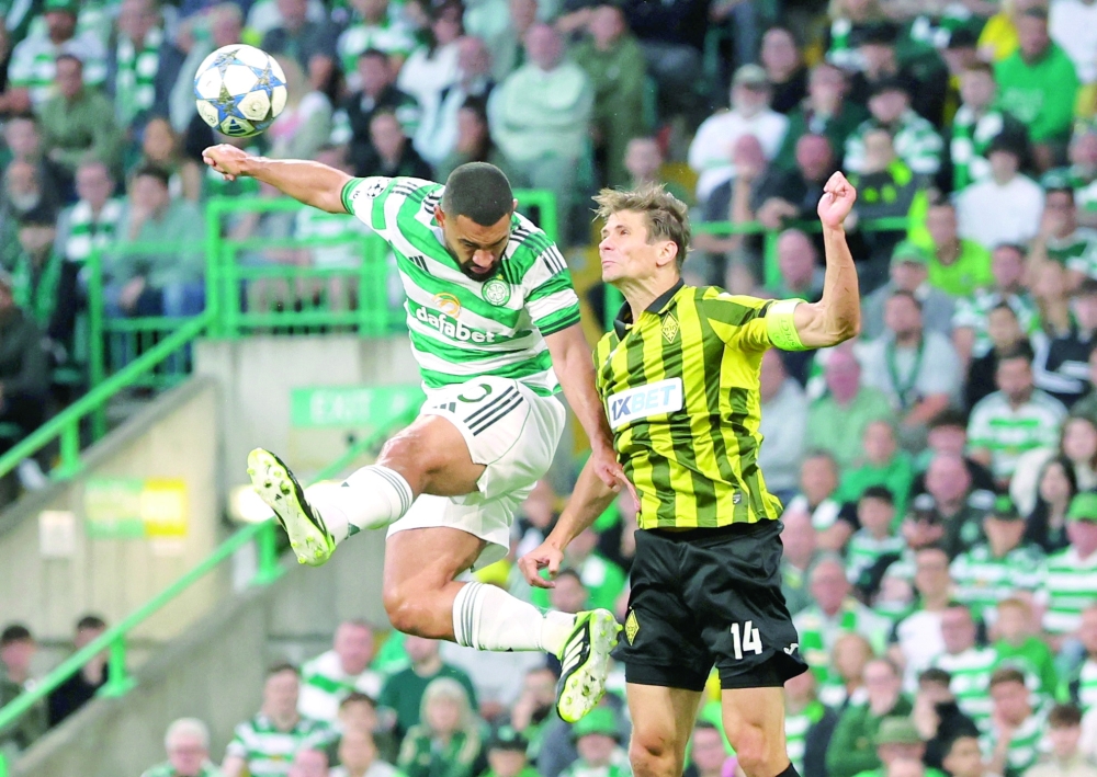 Celtic's Cameron Carter-Vickers in action with Kairat's Alyaksandr Martynovich. — Reuters