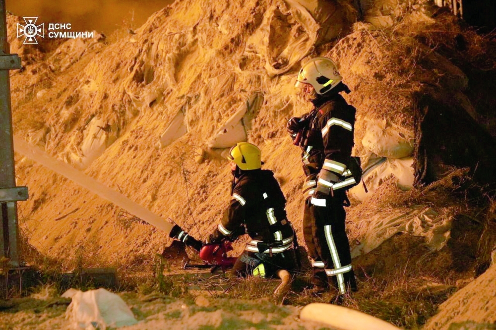 Firefighters work at the site of a Russian drone strike, in Sumy region, Ukraine. — Reuters